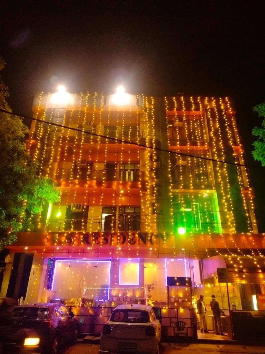 Hotel SS Residency building lit up in the evening